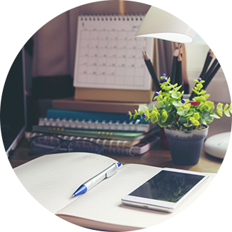 A book, a tablet, a plant and a calendar in an office